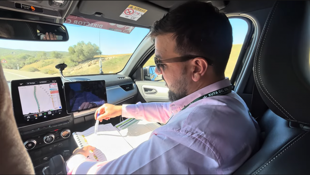 Pau Cuevas Roura in race organisers car with VeloViewer in view